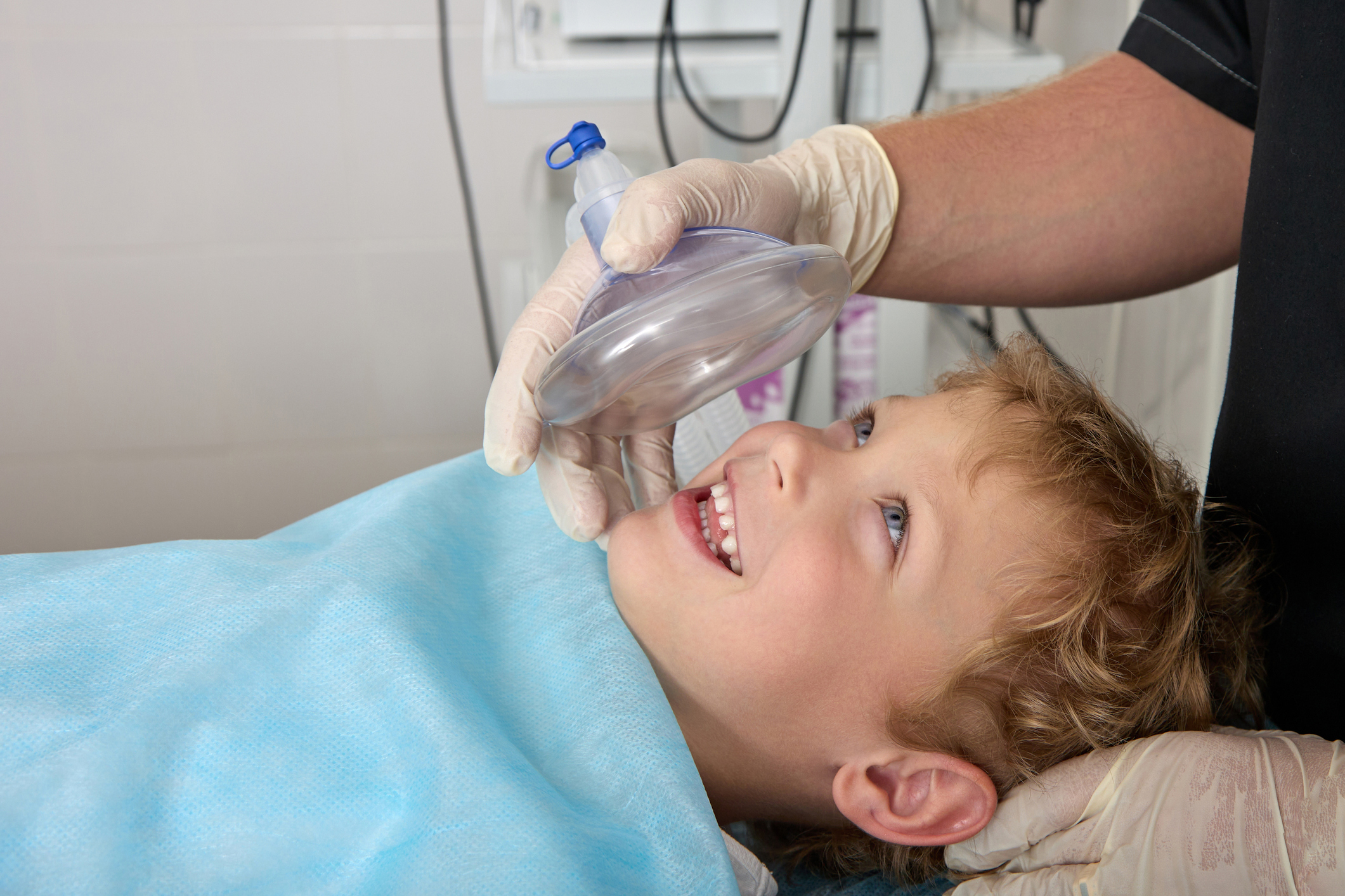 Courageous boy smiles and looks at doctor before operation on operating table Professional Teeth Whitening in Summerville SC